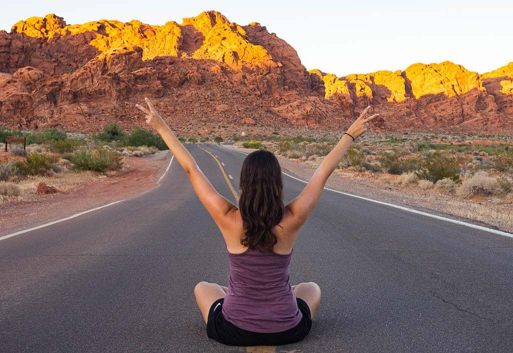 Dana sitting in the middle of the road in Valley of the Fire State Park