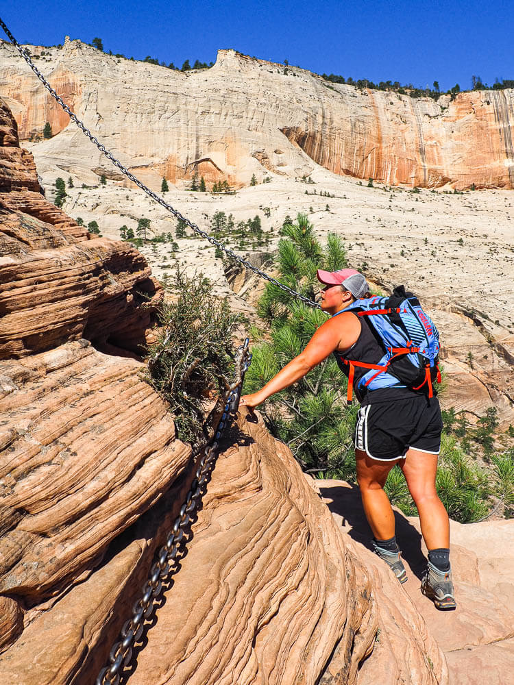 Rachel grabbing the bolted chains to hike Angels Landing