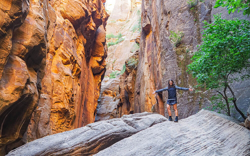 Dana standing on a massive rock in the Narrows