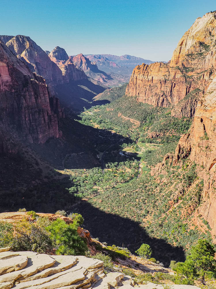 Towering canyon walls surrounding the green valley