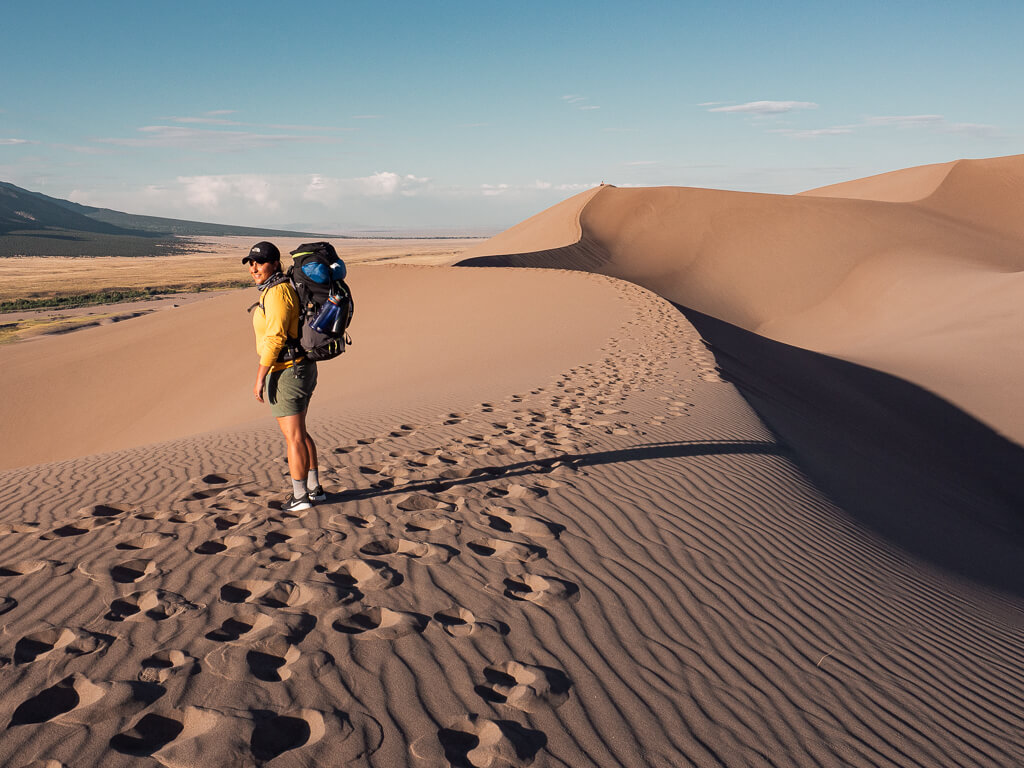 Rachel hiking down the Great Sand Dunes in Colorado