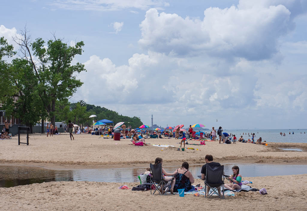 People sitting at the Indiana Dunes State Park Beach