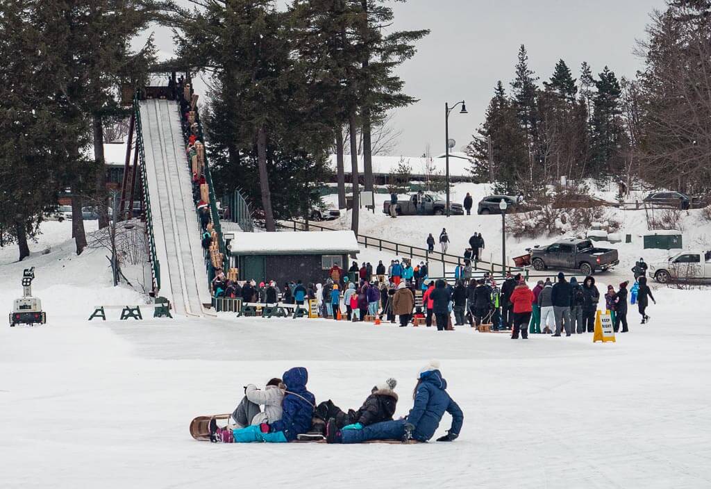 People sledding down the Toboggan Chute in the winter in Lake Placid