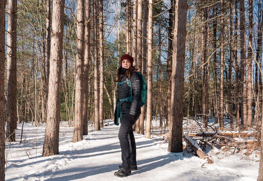 Dana hiking in the woods in winter in Lake Placid