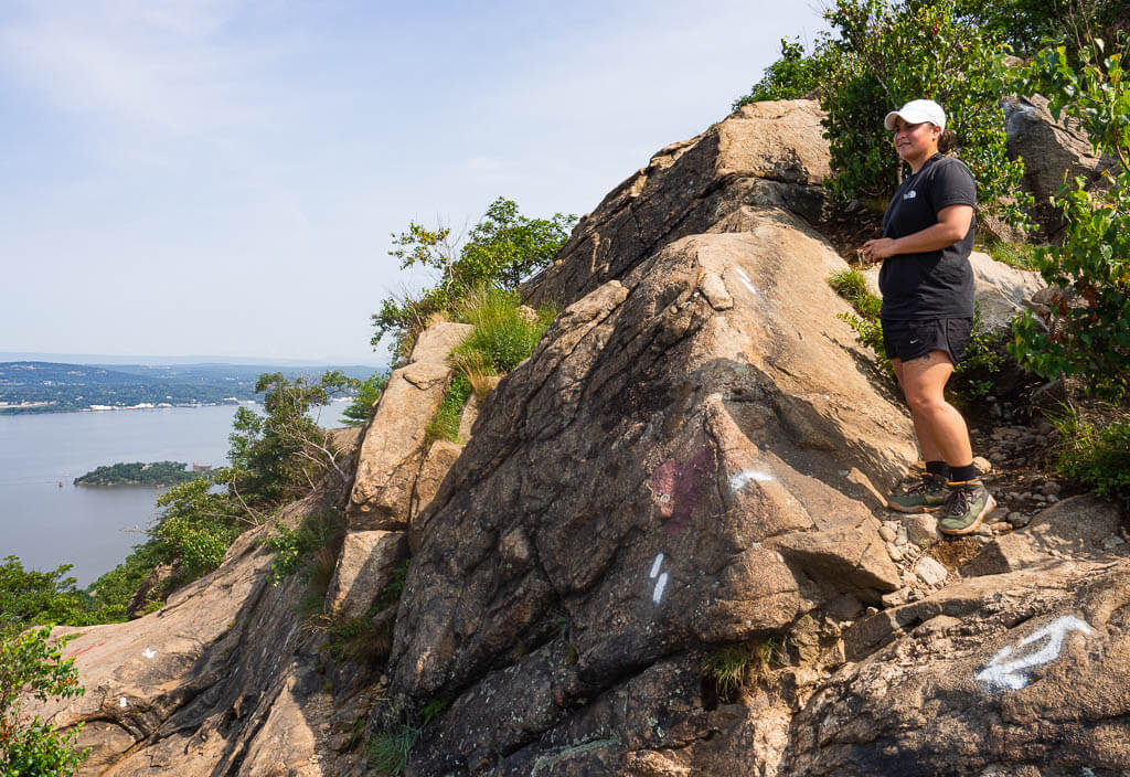 Rachel standing on a rock, overlook the Hudson River