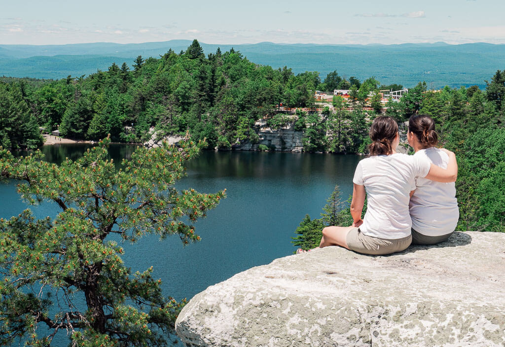 Us sitting on a cliff overlooking Lake Minnewaska