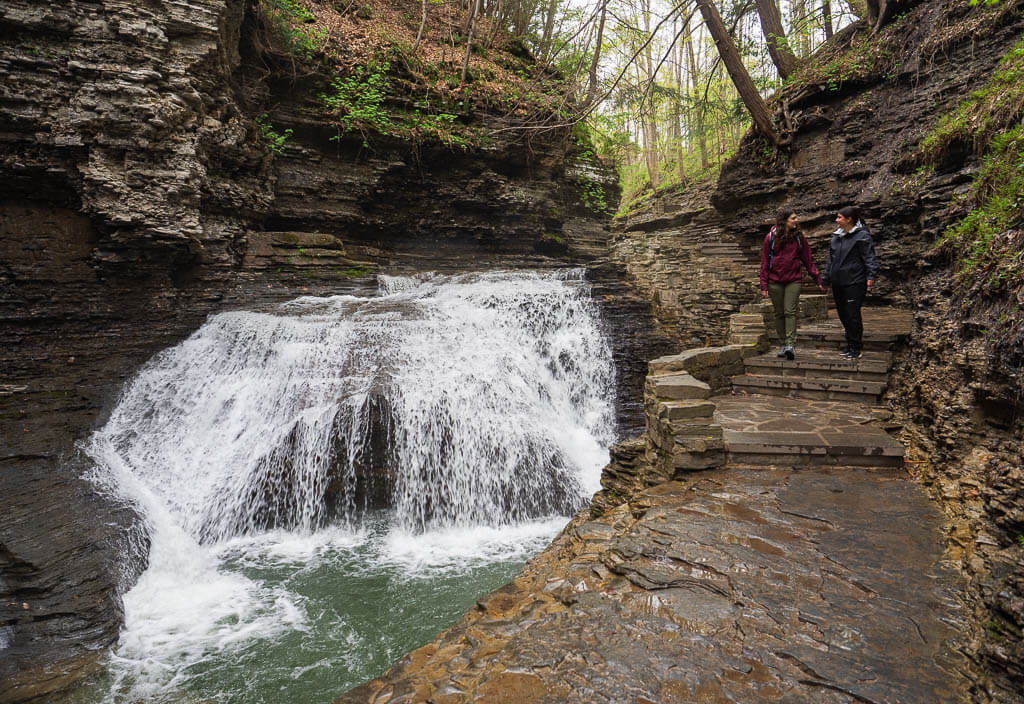 Us walking next to one of the cascading waterfalls in Buttermilk State Park