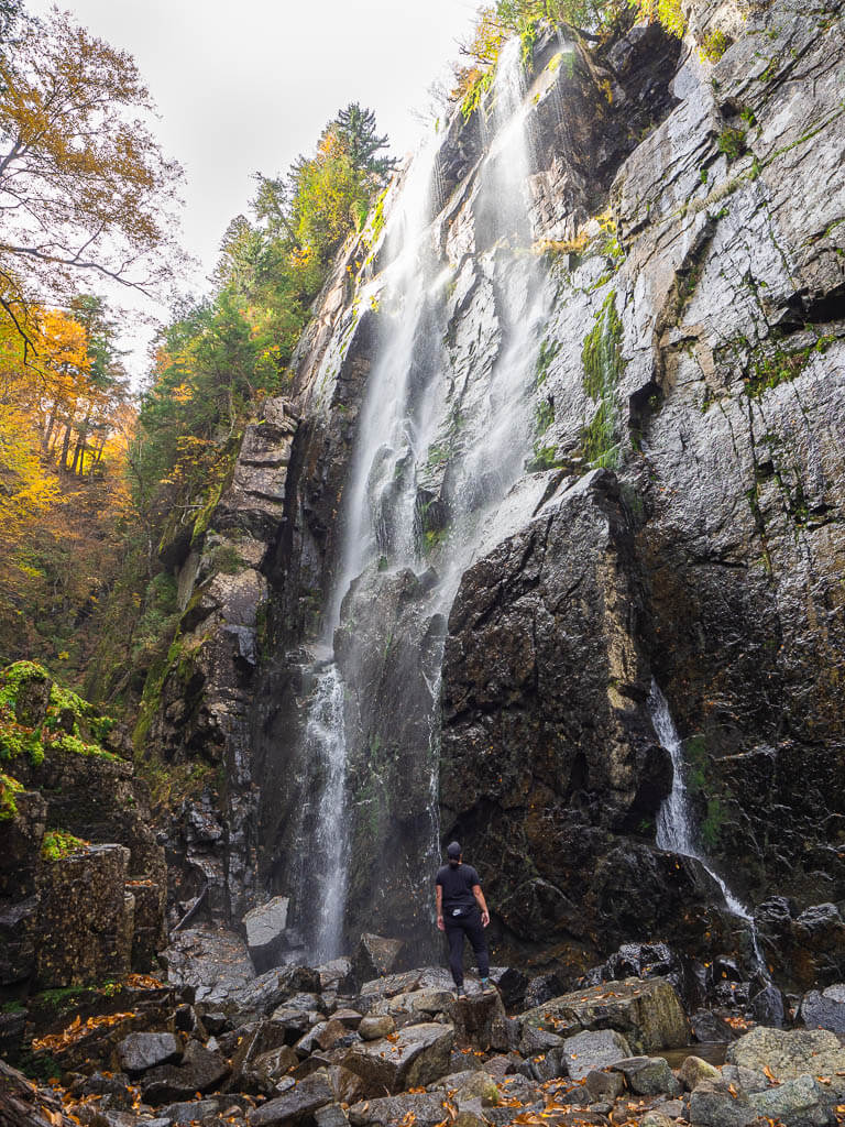 Rachel looking up the dramatic Rainbow Falls in Keene Valley