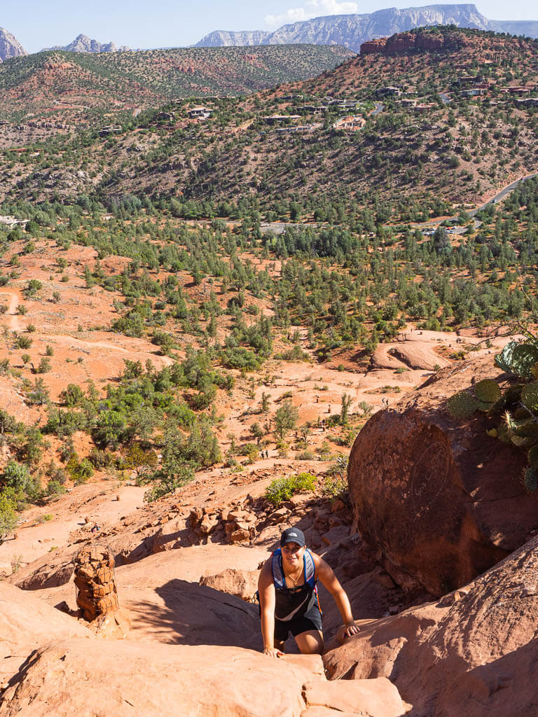 Rachel scrambling up a section of the Cathedral Rocks Sedona trail