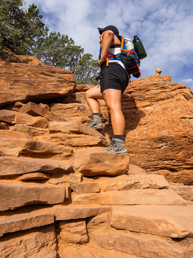 Rachel is hiking up natural stairs to get to Devils Bridges