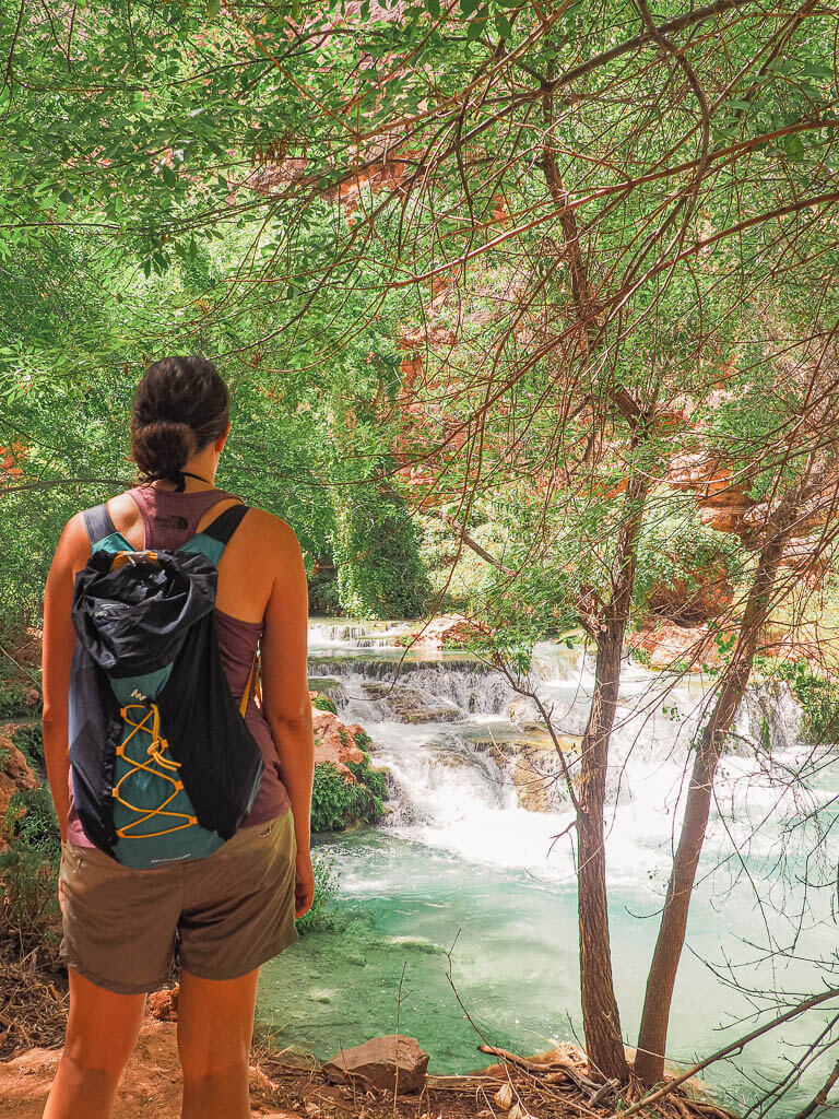 Dana standing in front of Beaver Falls in Havasu Creek