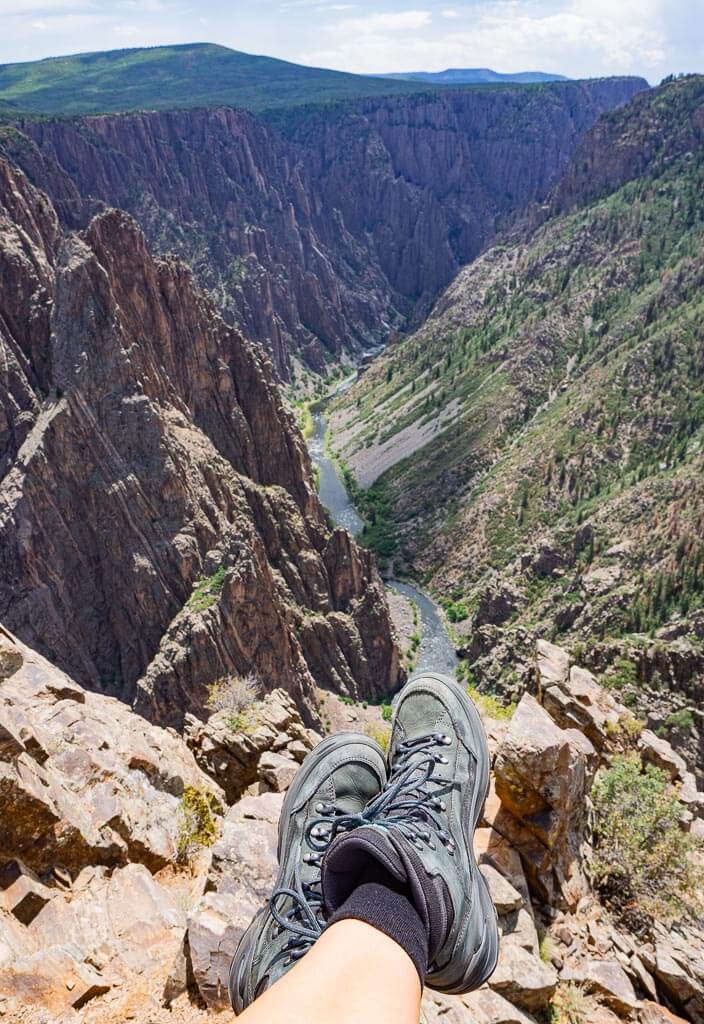 Dana sitting on a rock overlooking a canyon