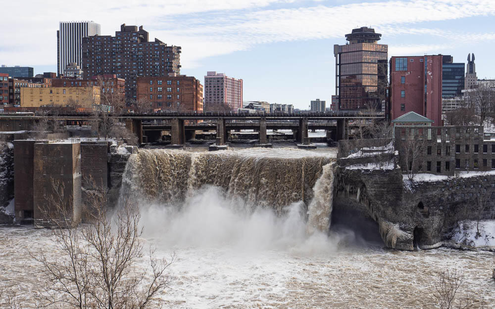 High Falls Rochester in front of the city skyline