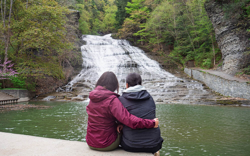 Rachel and I sitting in front of Buttermilk Falls, one of the Finger Lakes waterfalls