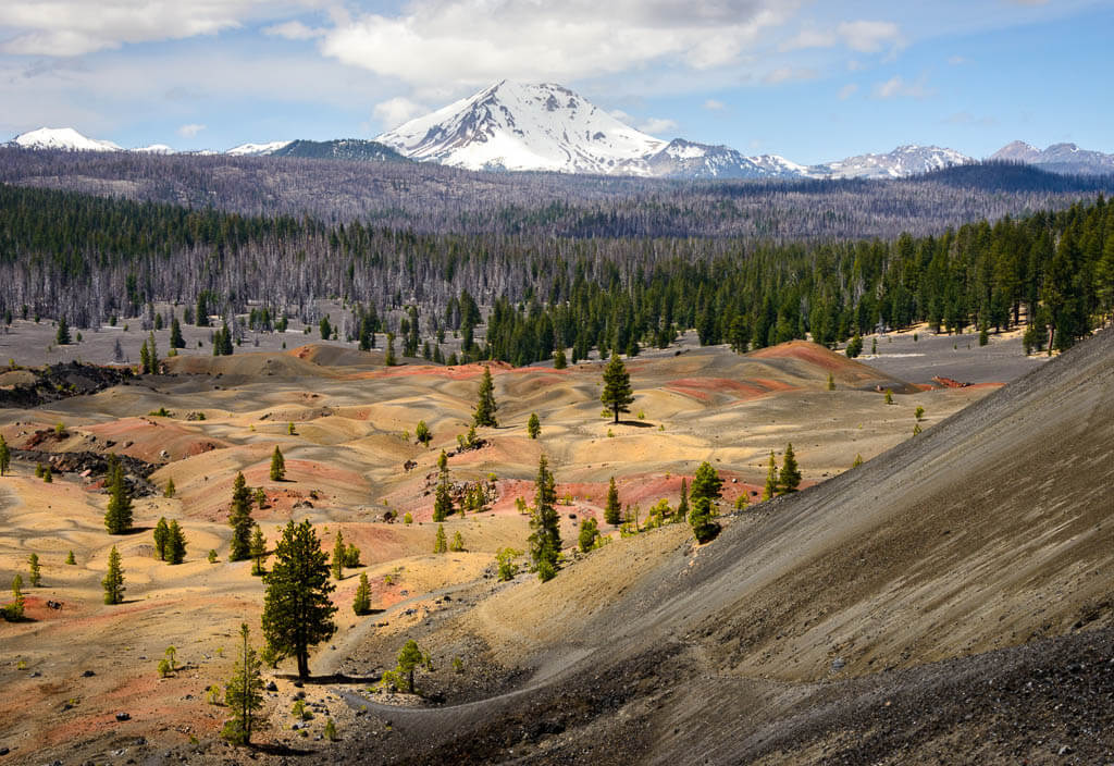Volcanic landscape in front of snowy mountain peaks in one of the west coast national parks, Lassen Peak.