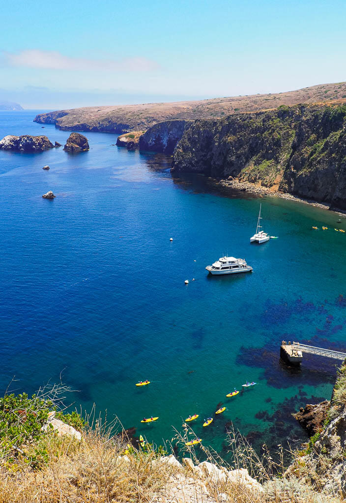Boats and kayaks in the deep blue waters of the Channel Islands