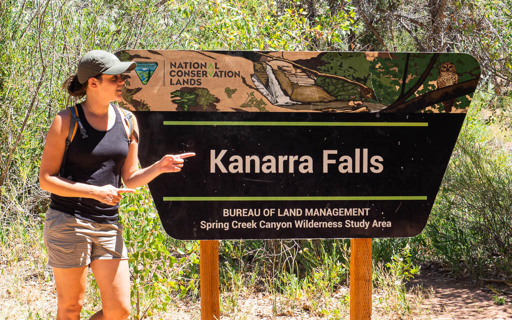 Dana standing next to the official Kanarra Falls sign