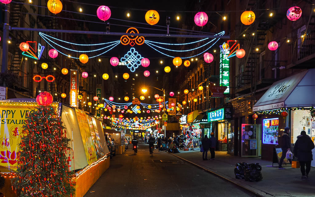 String lights hanging down in the streets of Chinatown New York City at  night