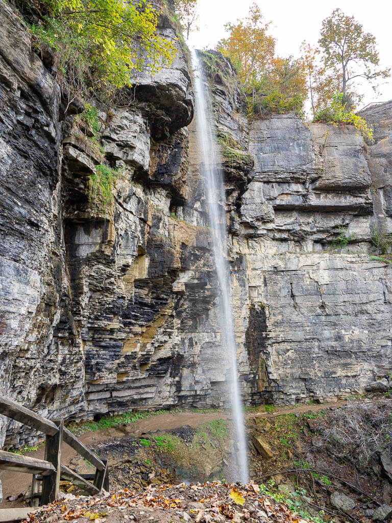 Walk behind the Outlet Falls on the Indian Ladder Trail