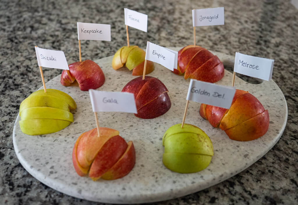 Apples sliced up on a cutting board