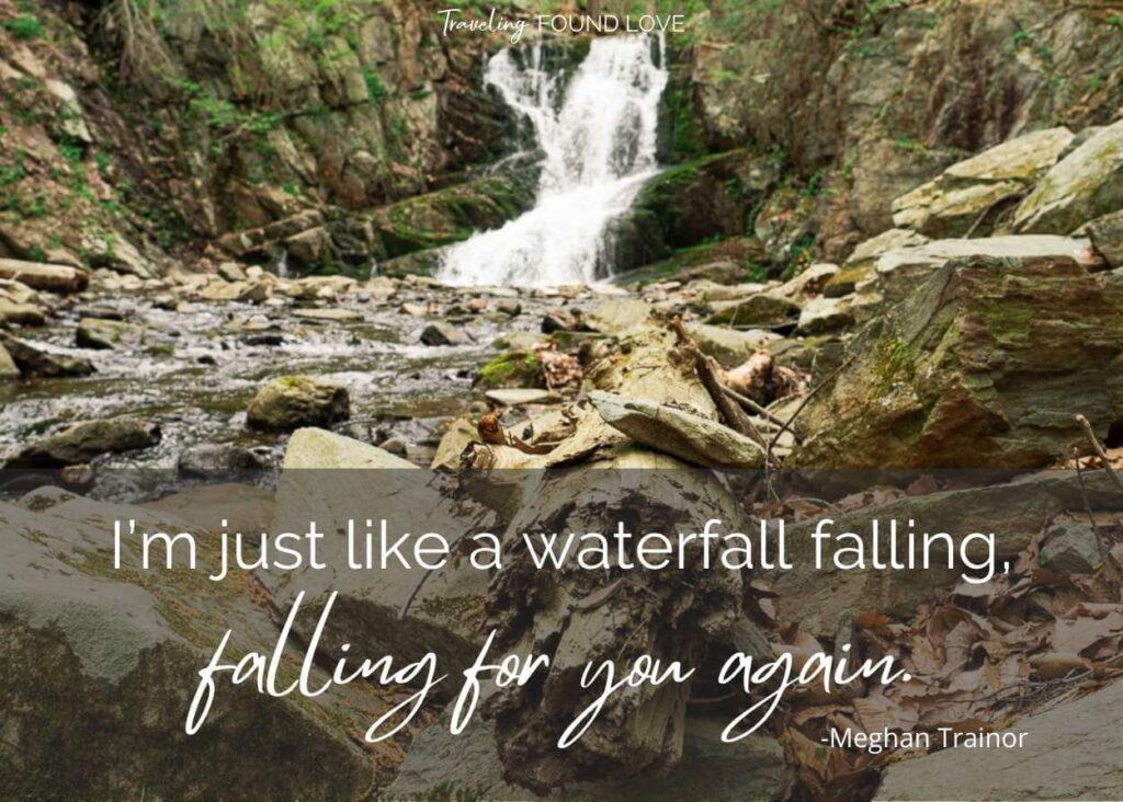 Rocks and wood in front of a waterfall